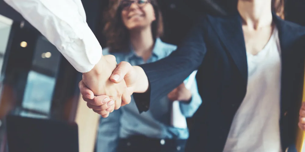 close up of people shaking hands